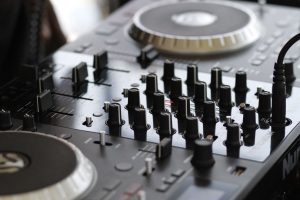 Detailed view of a professional audio mixing console with knobs and controls for sound engineering.
